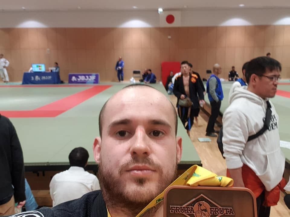 Kain with his medal at a jiu-jitsu competition